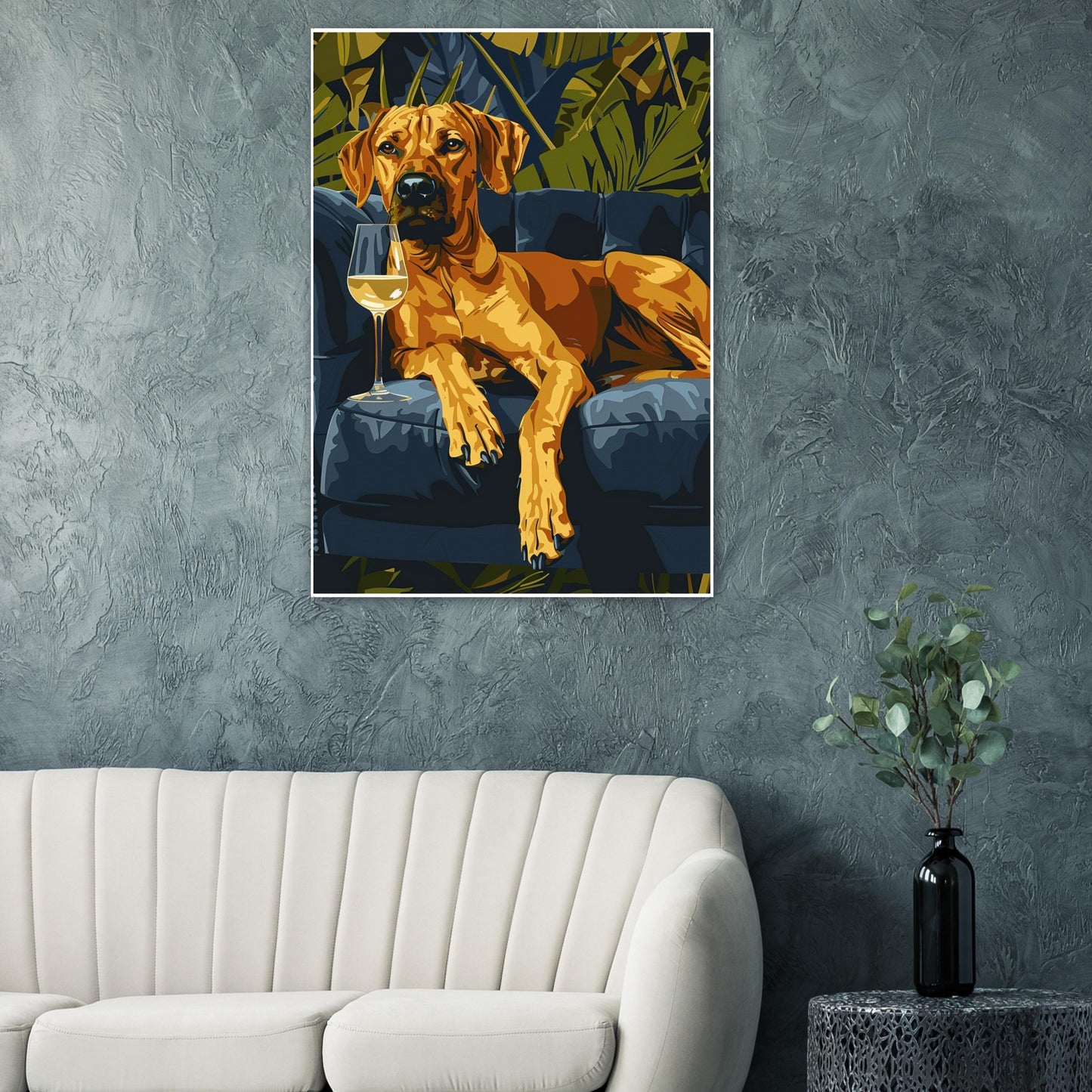 A framed Tropical Lounge Dog print displayed in a modern living room with warm lighting and soft décor. The deep blue sofa and lush green foliage in the artwork contrast beautifully with the room’s neutral tones, creating a stylish focal point that adds personality, warmth, and contemporary charm to the interior.